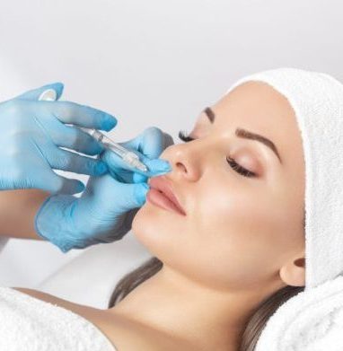 Lip augmentation procedure of a beautiful woman in a beauty salon