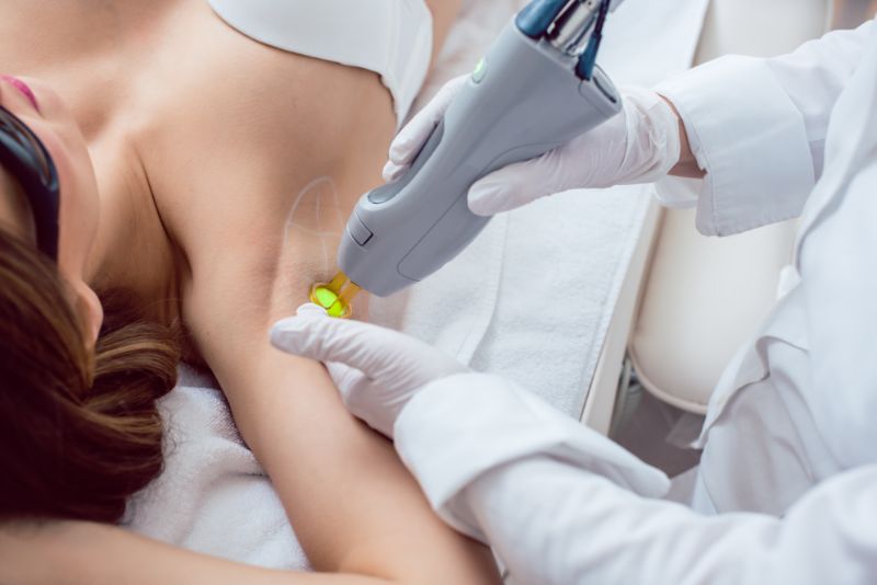 Woman during hair removal using modern laser technology